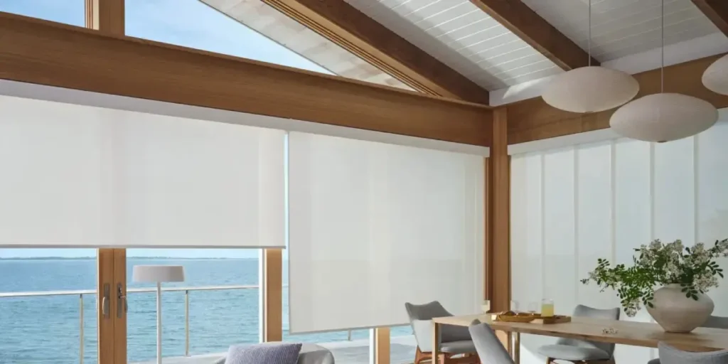 Hunter Douglas Designer Solar Shades as sunroom window treatments in a space overlooking water
