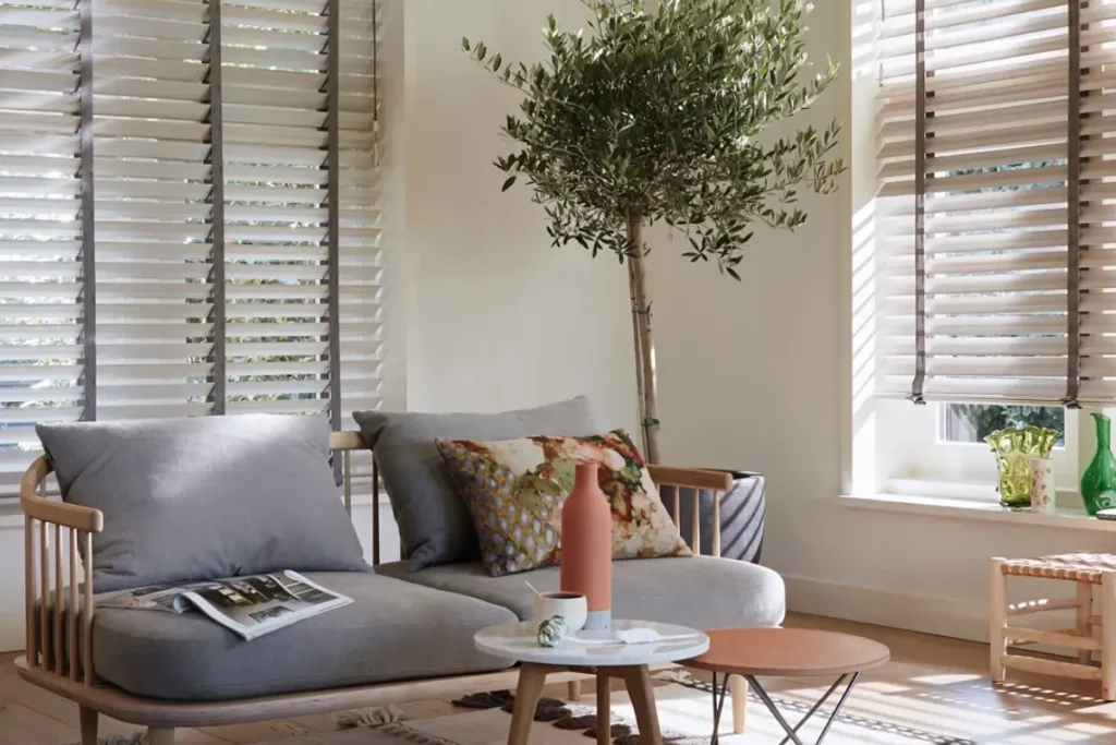 Hunter Douglas Parkland® Wood Blinds with decorative tape on gorgeous living room windows